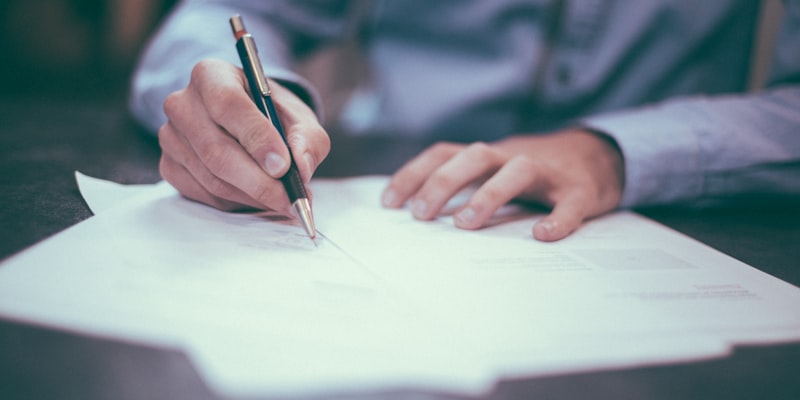 Business person reviewing paperwork at desk