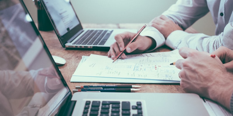 Business person doing paperwork with a pencil and paper