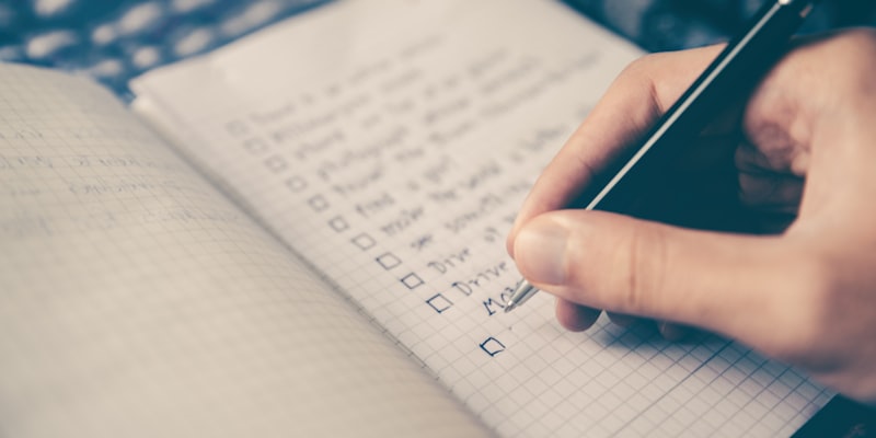 Overhead shot of man writing on graph paper